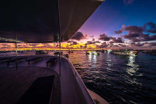 Experience a tranquil sunset cruise aboard a luxury yacht in the Maldives with colorful sky and serene waters.