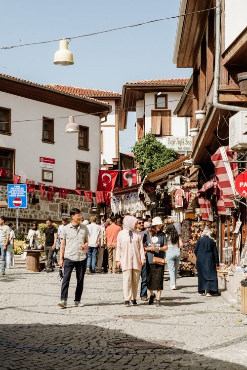 Free Vibrant street market in Ankara, featuring local shops and Turkish flags. Stock Photo