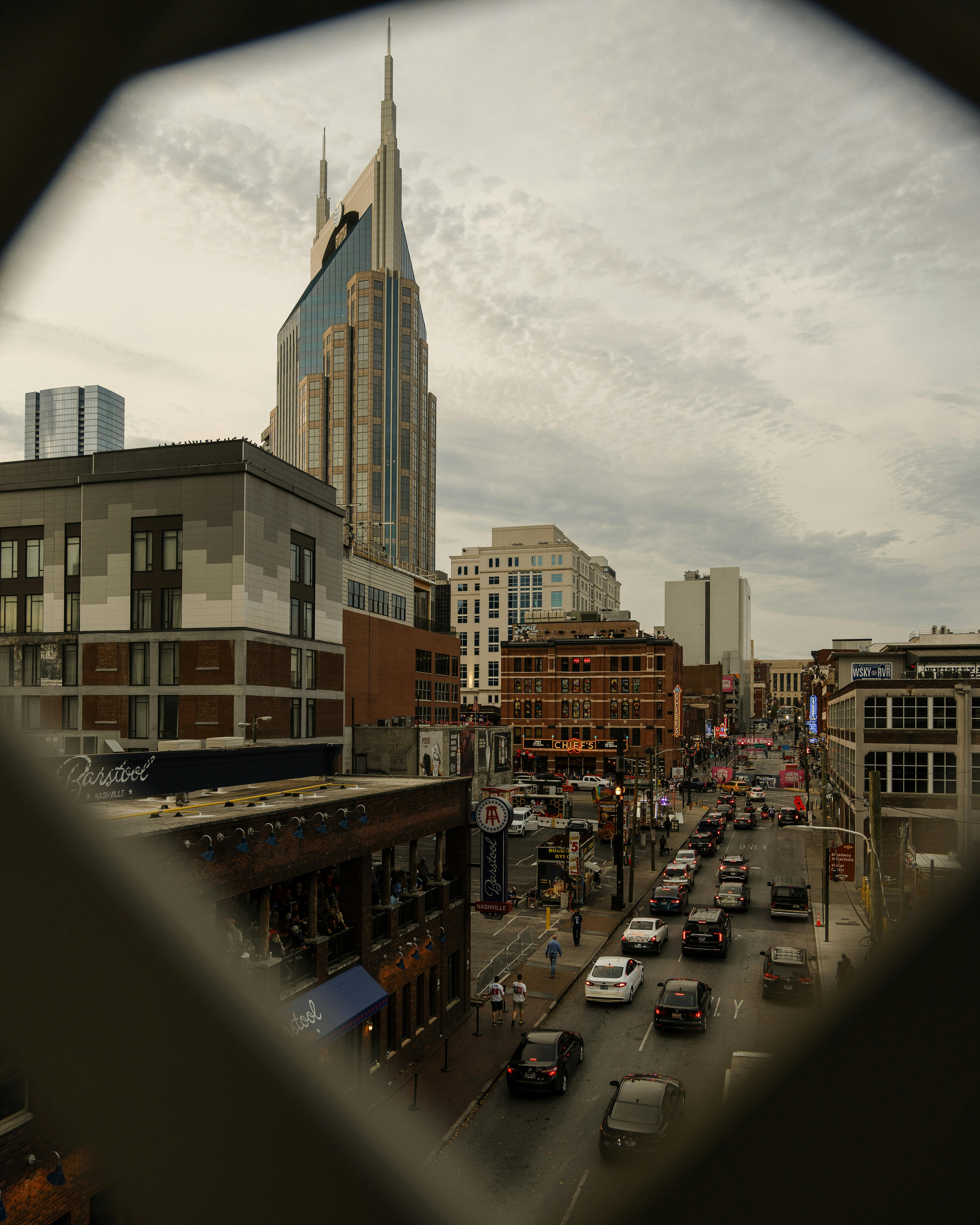 Vibrant downtown Nashville with iconic skyscrapers and busy streets.