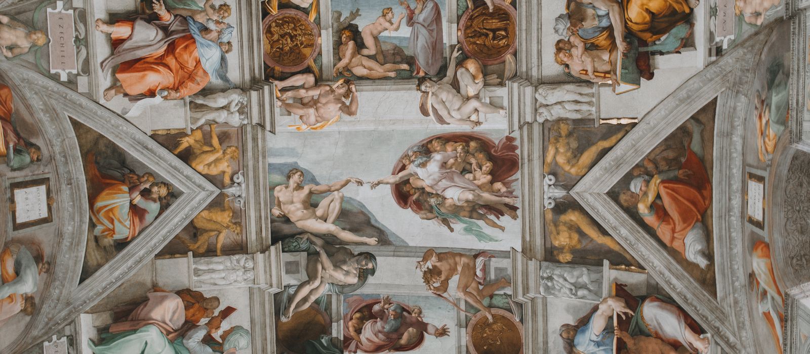 Intricate fresco artwork on the Sistine Chapel ceiling by Michelangelo in Vatican City.