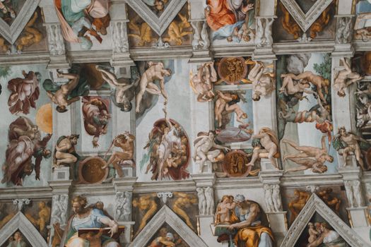 Intricate frescoes on the Sistine Chapel ceiling by Michelangelo, Vatican City.