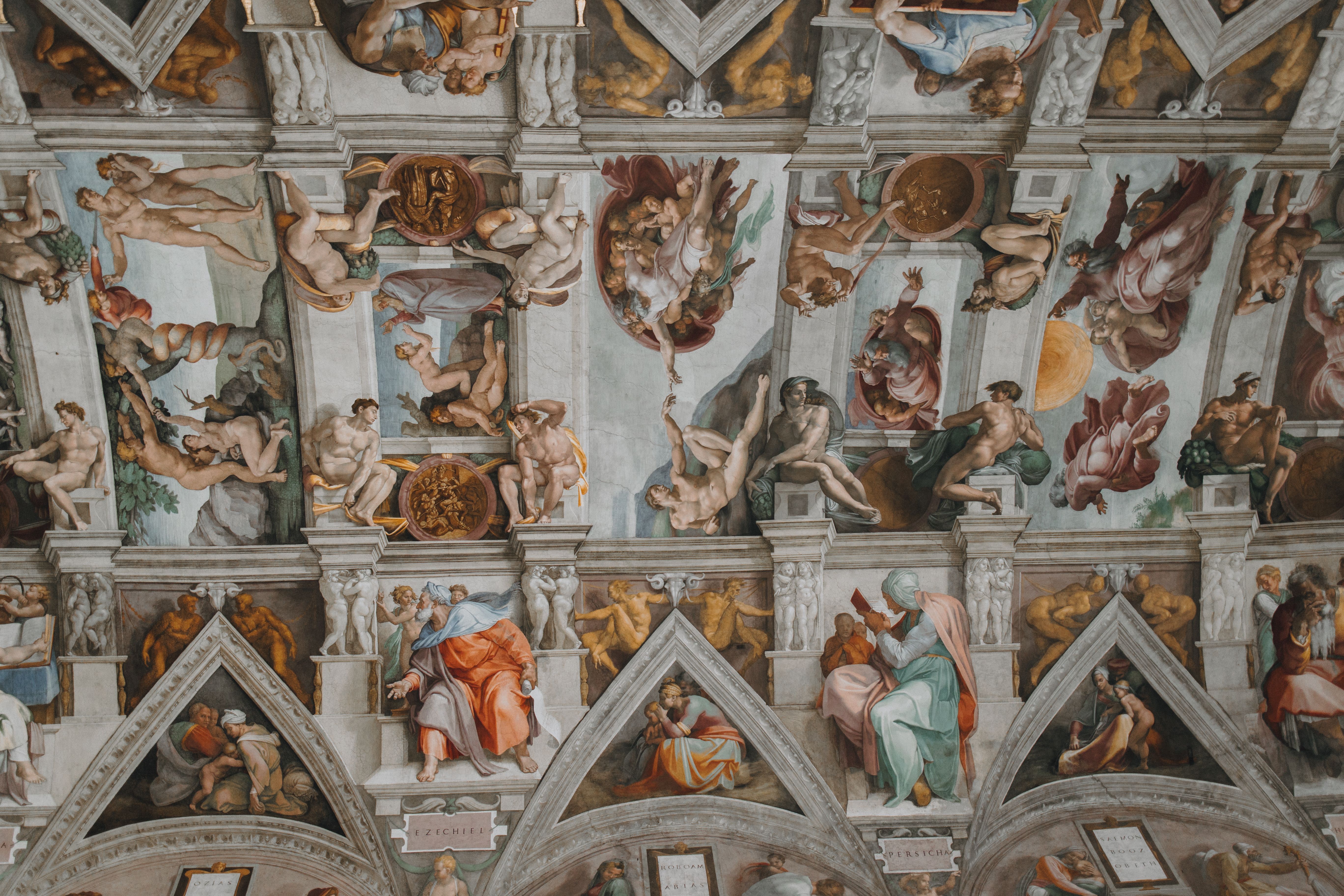 Iconic Sistine Chapel ceiling painting highlighting biblical scenes and figures by Michelangelo.