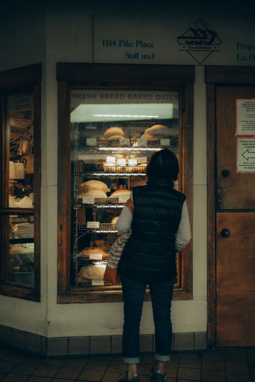 Free Woman shopping for artisan bread at Pike Place Market in Seattle. Stock Photo