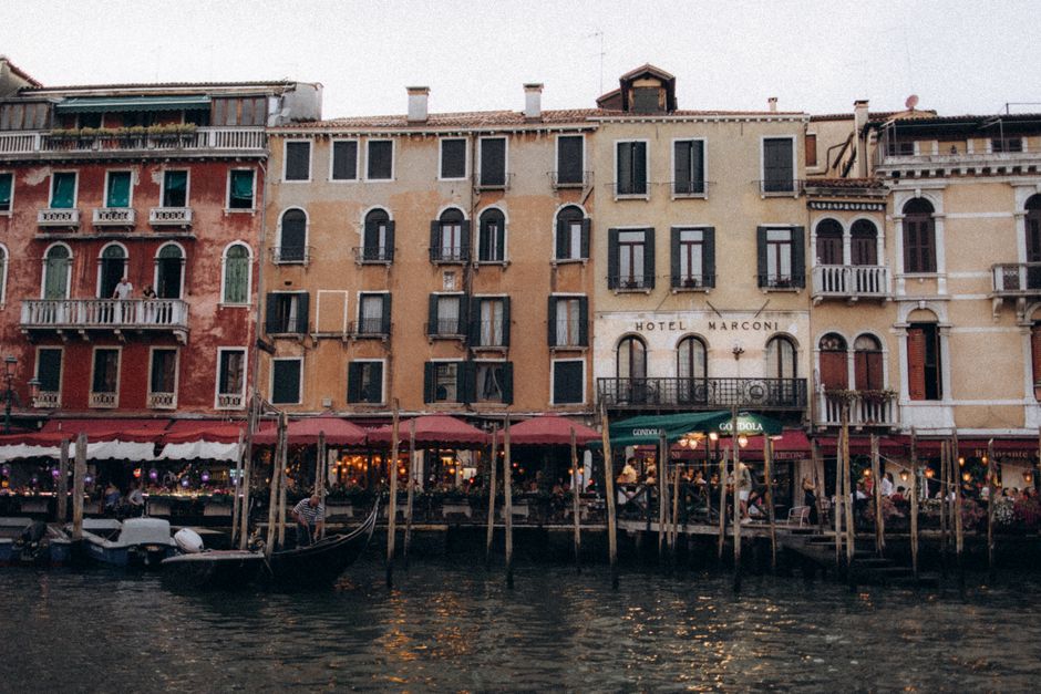 Scenic view of colorful buildings along a Venice canal with gondolas.