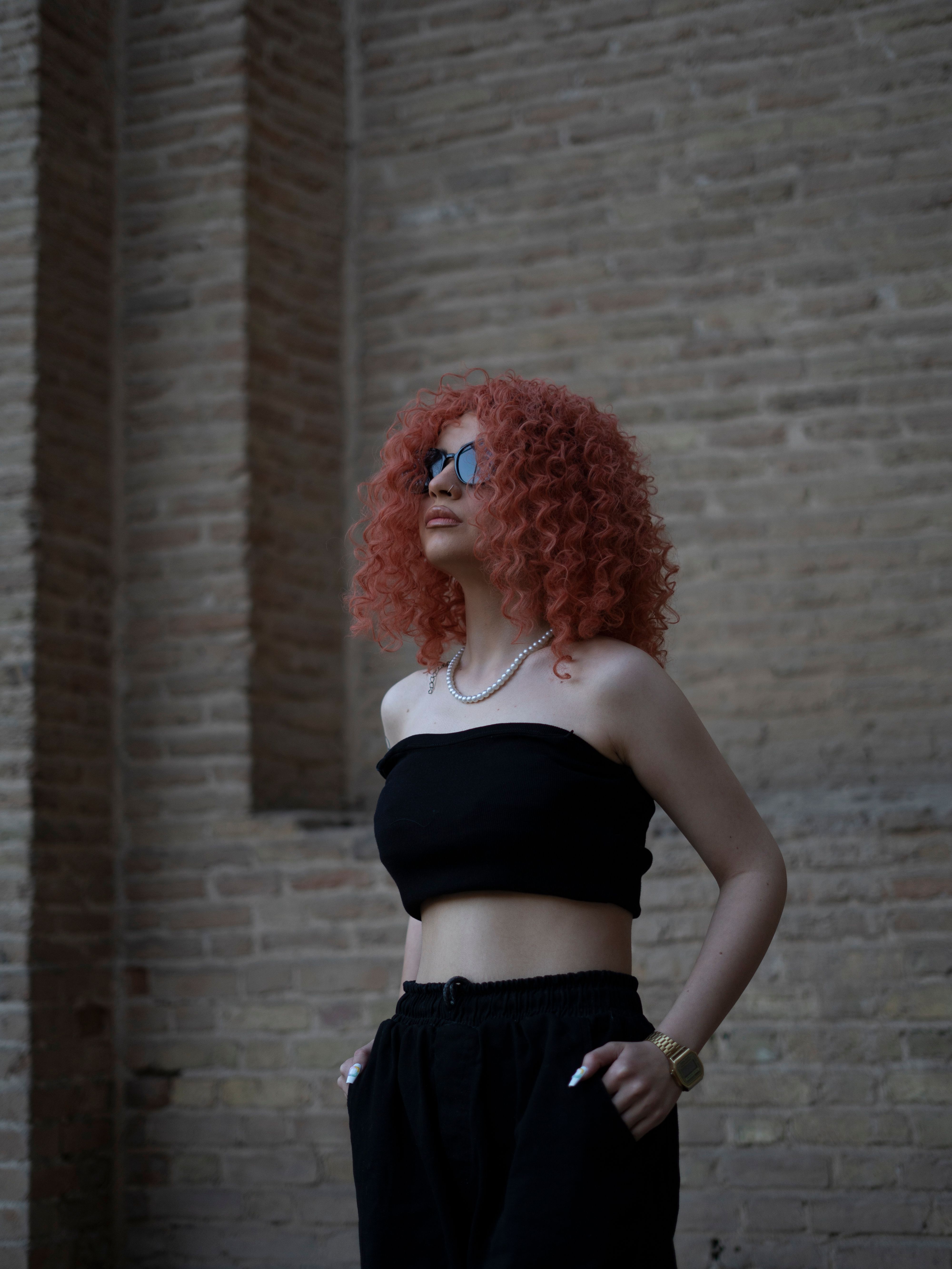 Portrait of Woman with Curly Red Hair Outdoors · Free Stock Photo