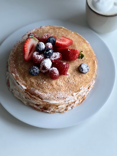 Free A mouth-watering stack of pancakes topped with fresh berries and powdered sugar. Stock Photo