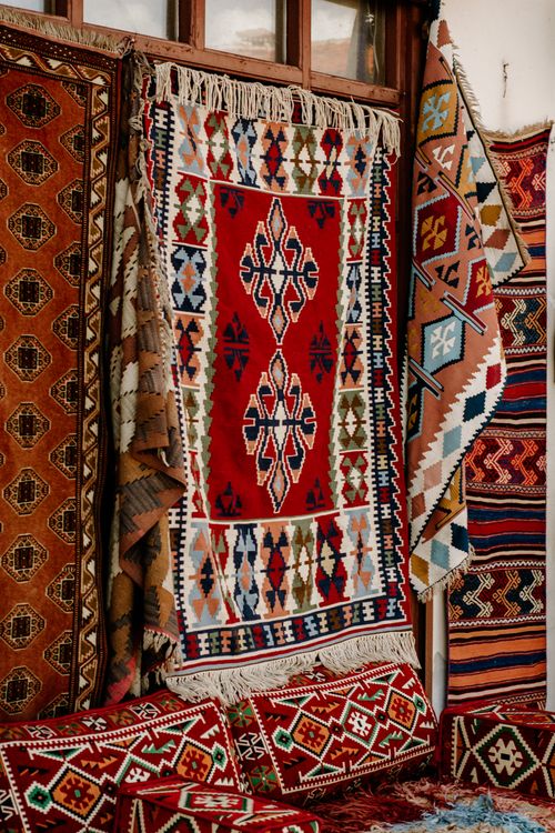 Traditional Rug Textile Traditional Colorful Handwoven Rugs and Carpets Display · Free Stock Photo