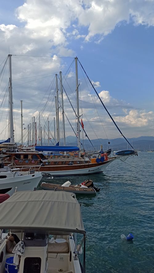 Free Serene view of sailing boats docked at Fethiye Marina under a partly cloudy sky. Stock Photo