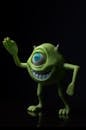 Green Cyclopean Toy Figure on Dark Background