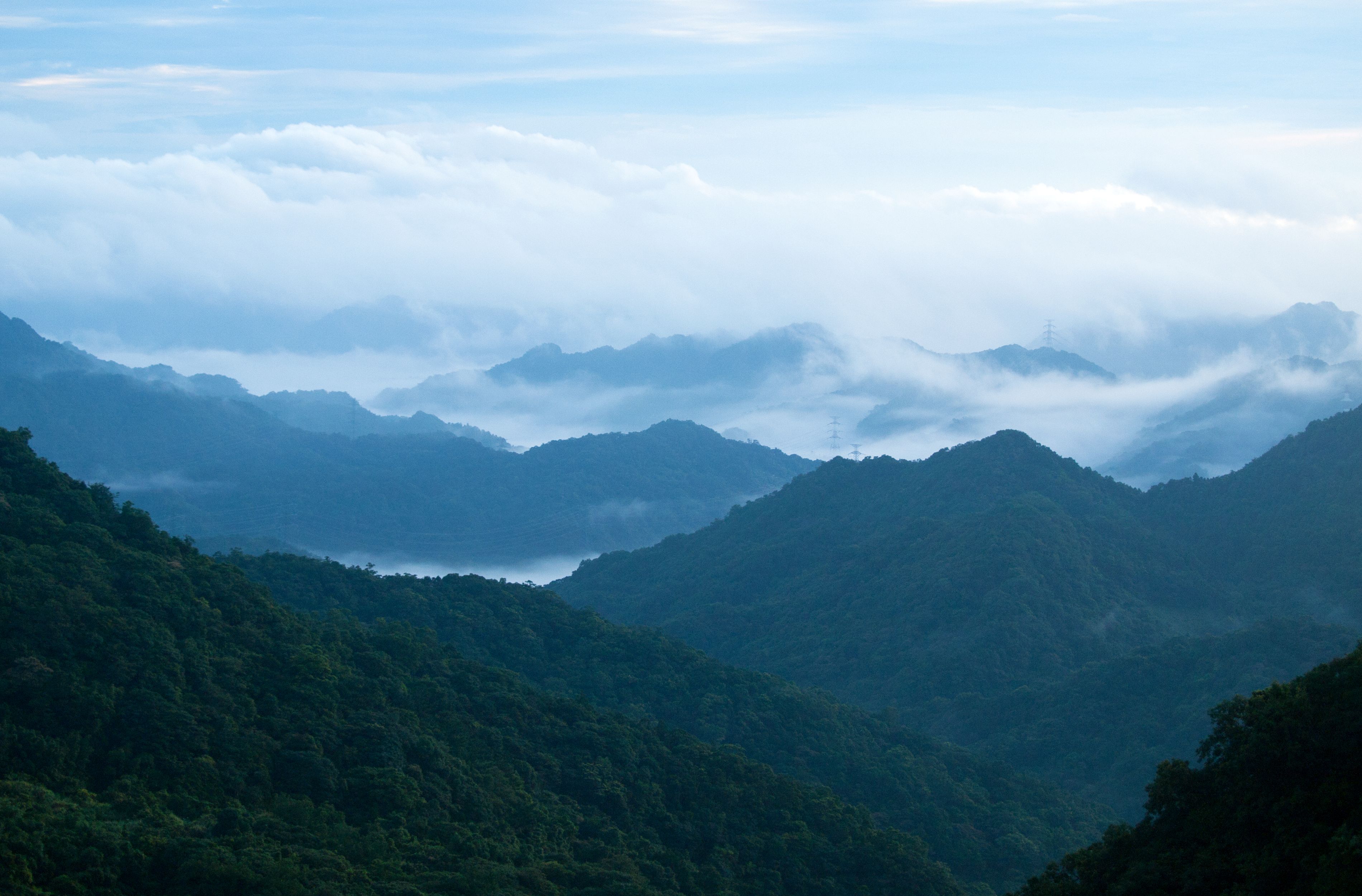 Misty Blue Mountains Under Cloudy Sky · Free Stock Photo