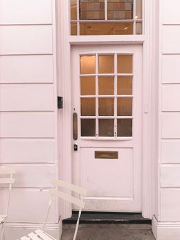 Elegant vintage white door with glass panels and a minimalistic outdoor setup.