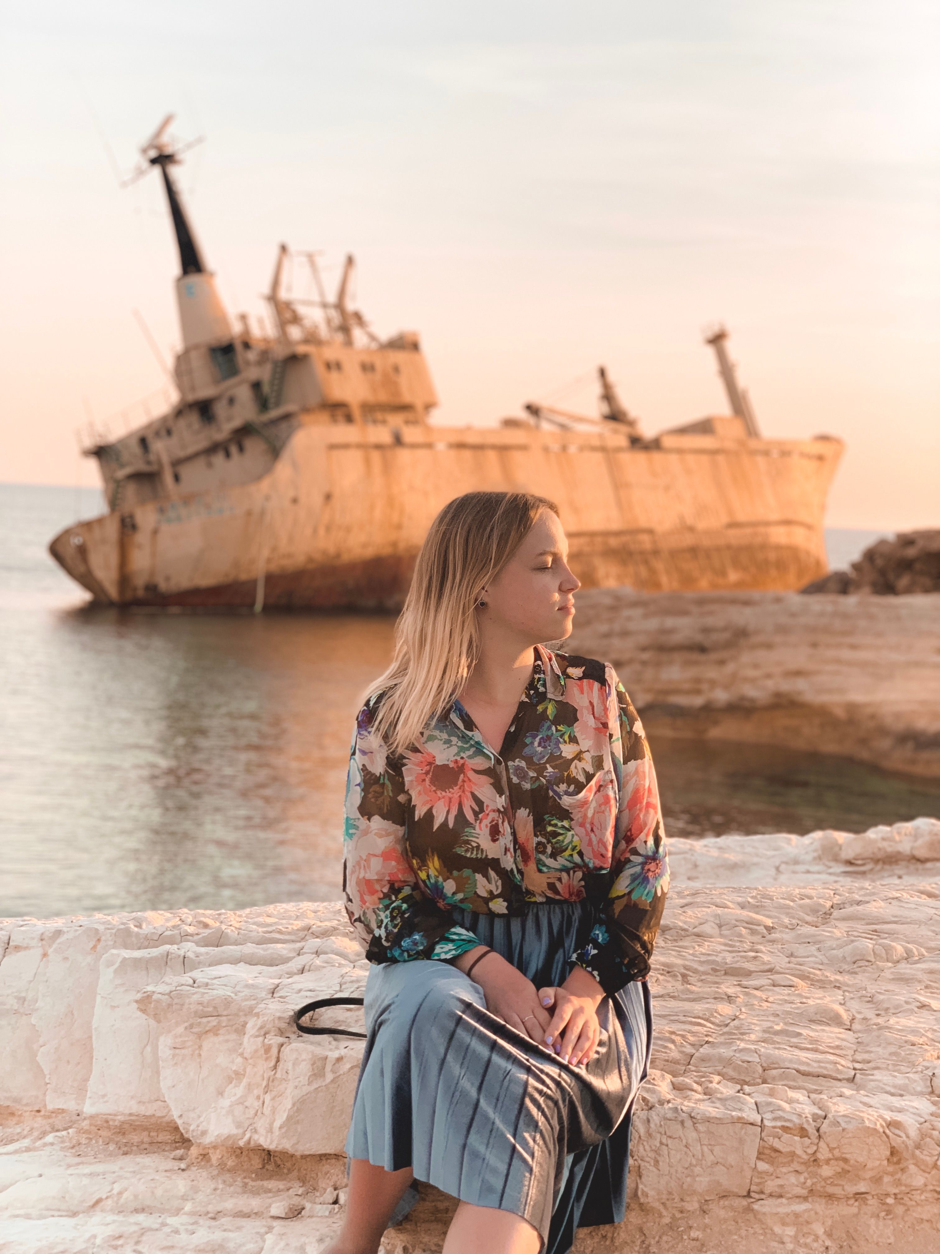 Woman Sitting on Concrete Dock · Free Stock Photo