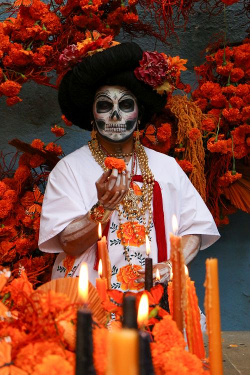 Free Colorful Day of the Dead celebration with traditional attire and skull makeup. Stock Photo