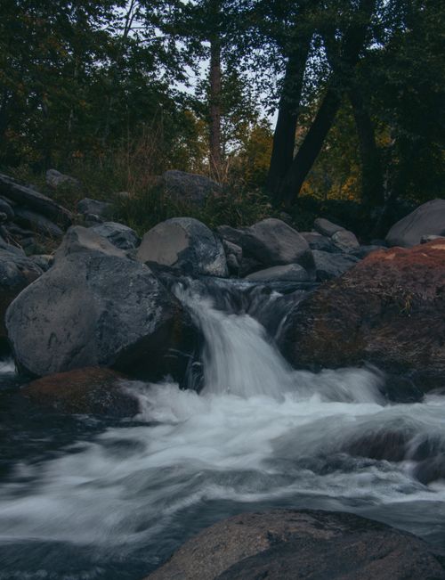 Free A tranquil stream flowing through Sedona's rocky landscape, capturing summer's serene beauty. Stock Photo