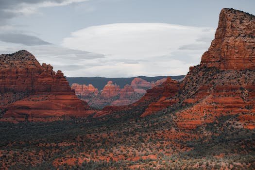 Breathtaking view of the iconic red rock formations in Sedona under a cloudy sky.