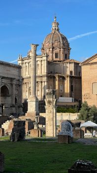 Explore ancient Roman ruins and Baroque architecture under a clear blue sky.