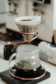 Close-up of a stylish pour-over coffee brewing setup on a kitchen counter.