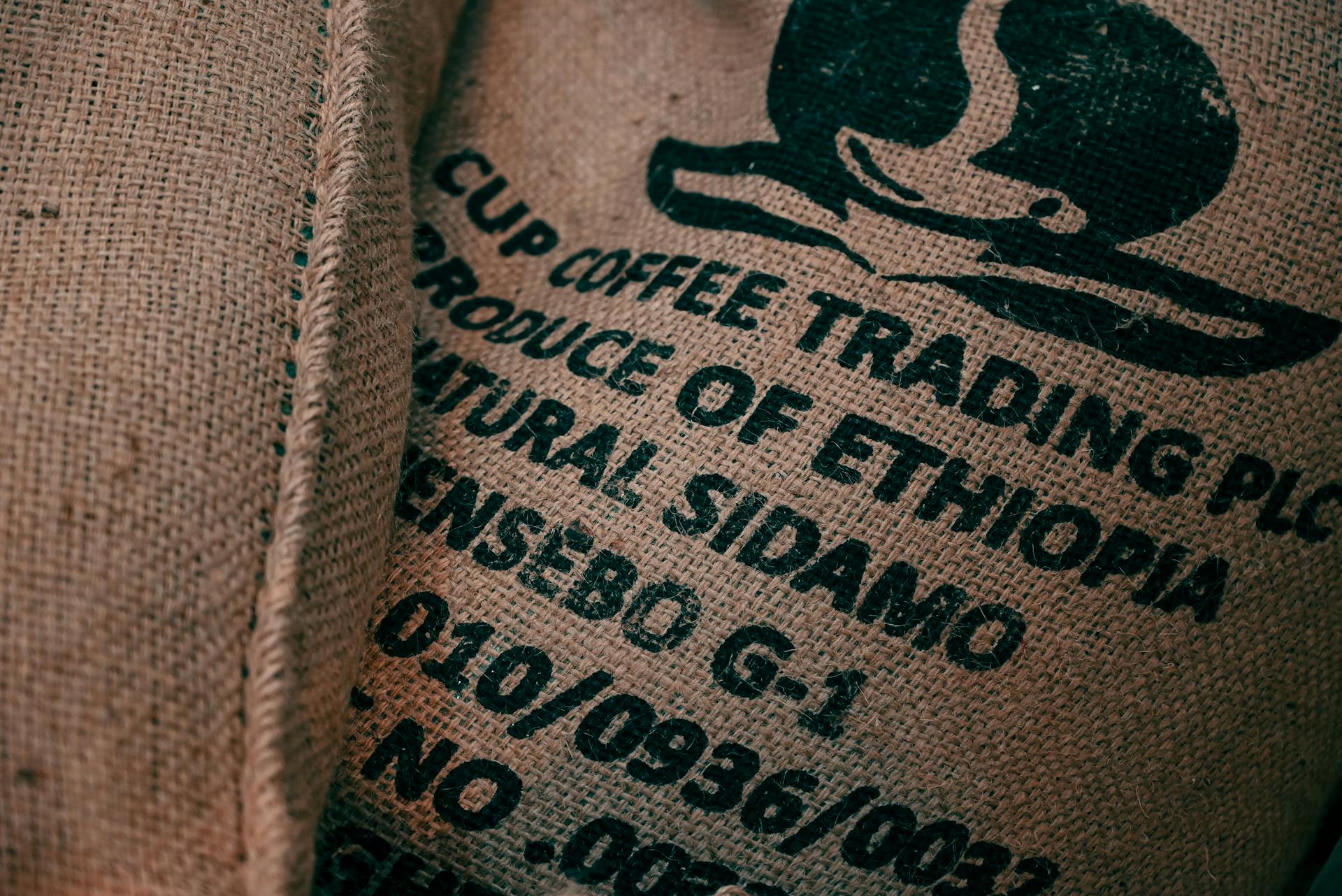 Close-up of burlap sack with Ethiopian coffee logo and text, showcasing texture.