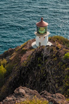 Photo by Cristian Benavides A stunning view of Makapu'u Point Lighthouse on Oahu's coast overlooking the blue sea.