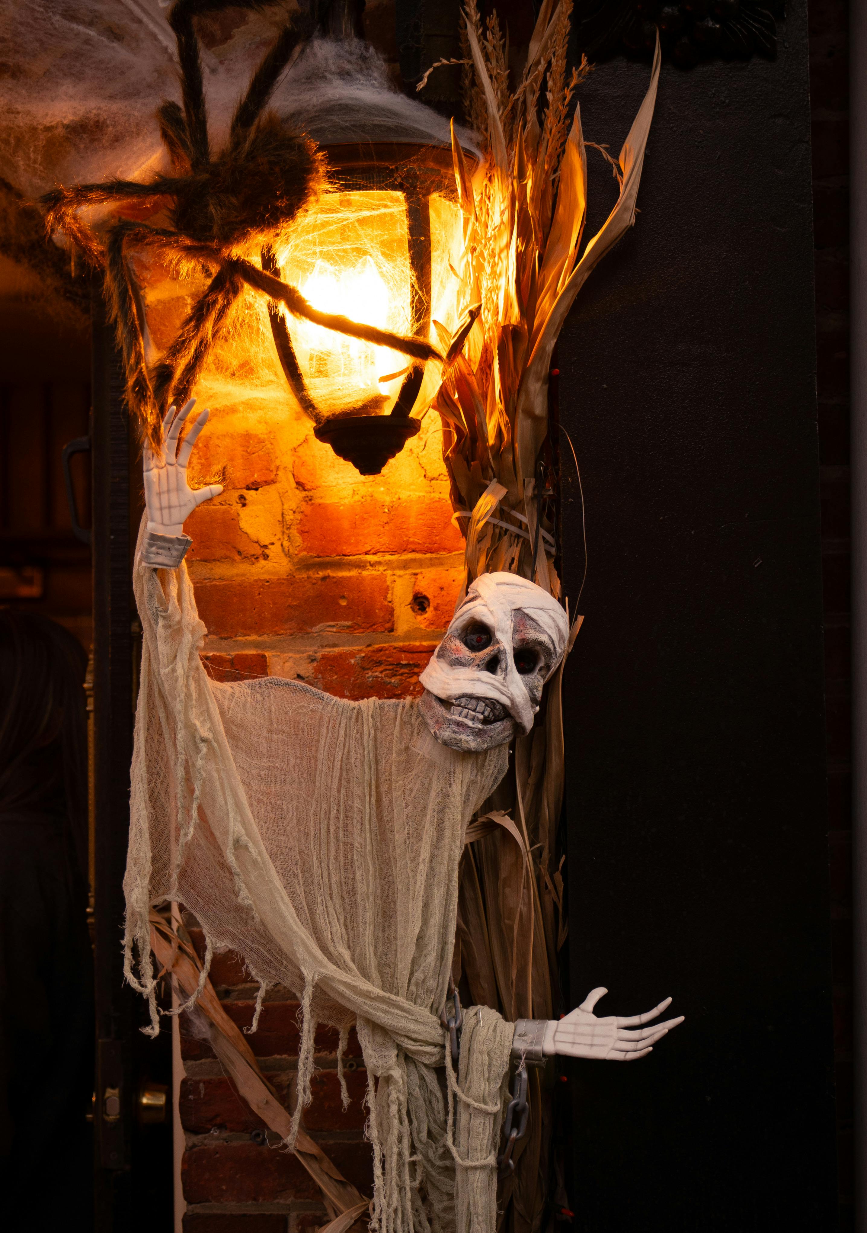 Chilling Halloween decoration featuring a ghostly figure and cobwebs in dim lighting.
