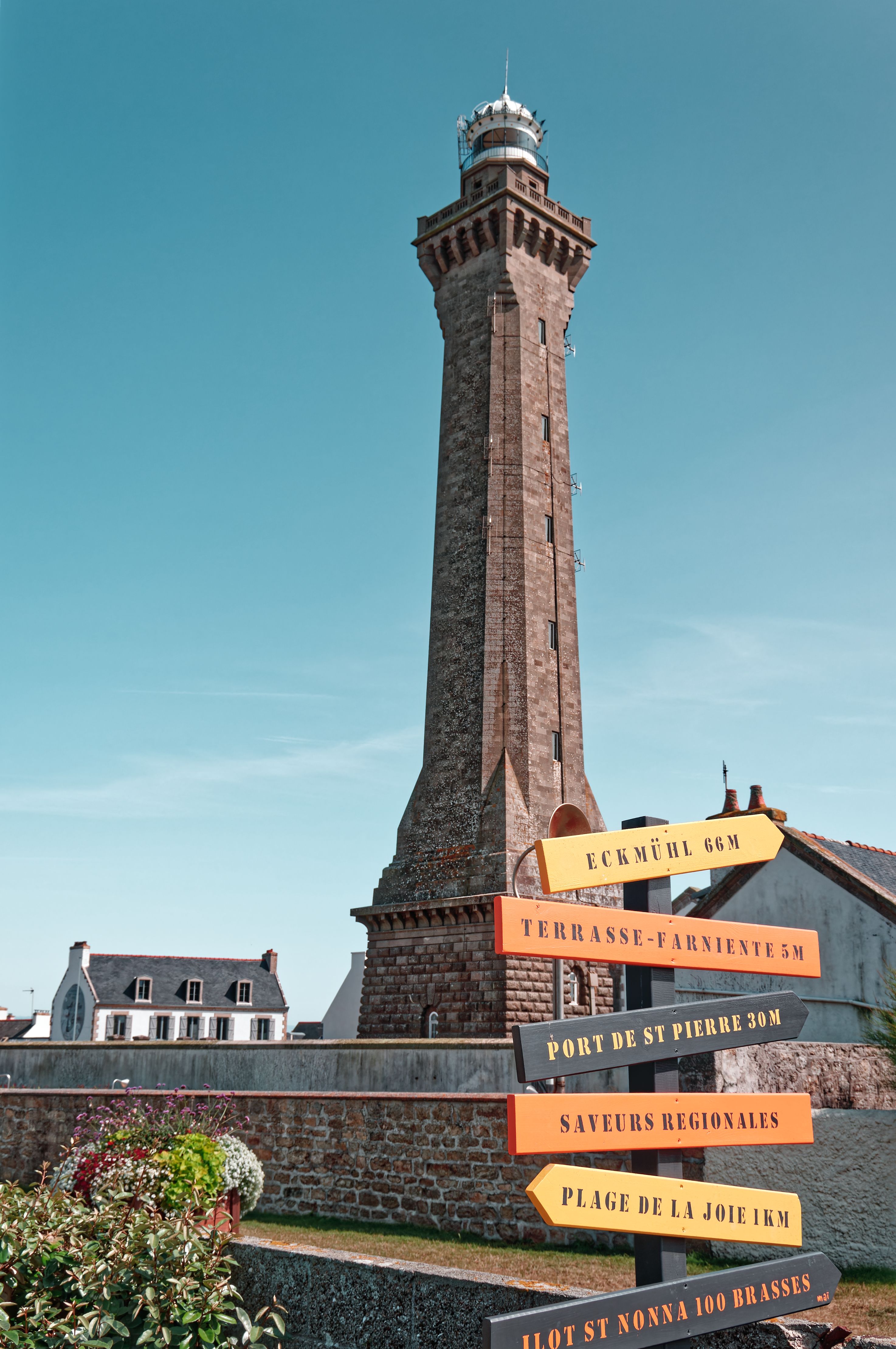 Discover the Penmarc'h Lighthouse and vibrant signage in Bretagne, France.