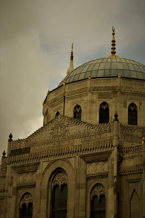 Free Ornate dome of a historical building with intricate designs against a moody sky. Stock Photo