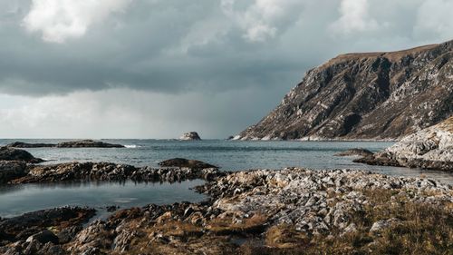 Free Stunning view of rocky cliffs and the Atlantic Ocean under a cloudy sky. Stock Photo