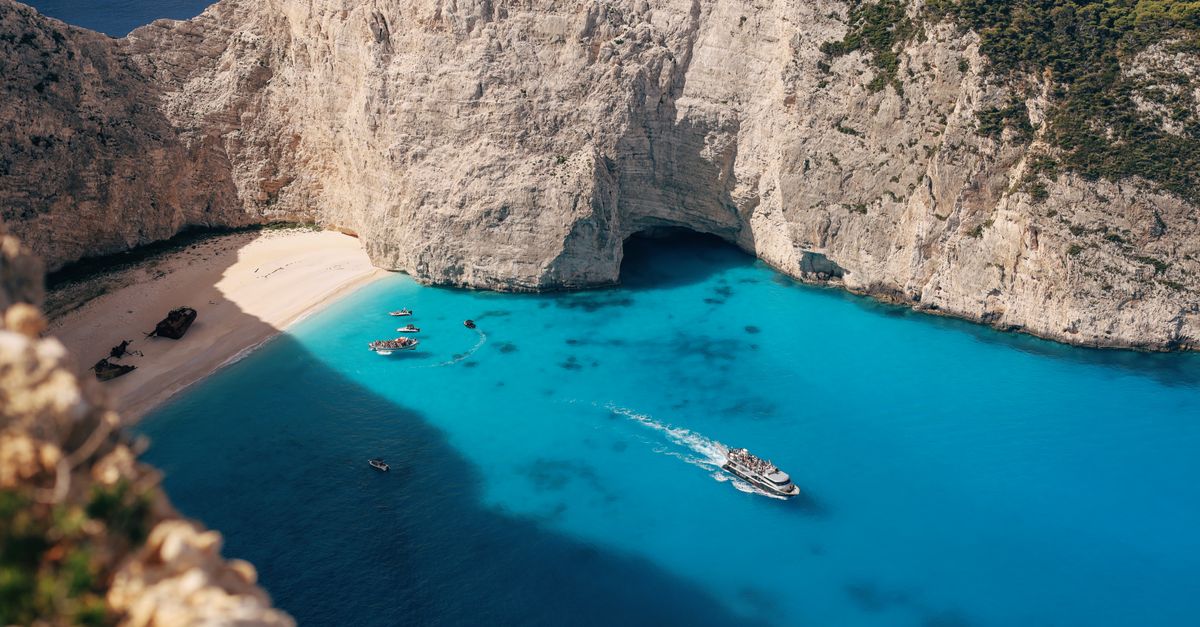 Navagio beach on Zakynthos in Greece, a cove enclosed by white cliffs