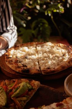 Close-up of artisan pizza with melted cheese and veggies, perfect for food lovers.
