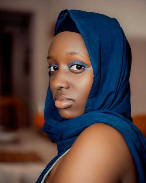 Free Striking indoor portrait of a woman wearing a blue hijab, emphasizing elegance. Stock Photo