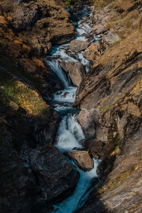 Free A mountain stream cascading over rocks creating a dramatic natural scene. Stock Photo