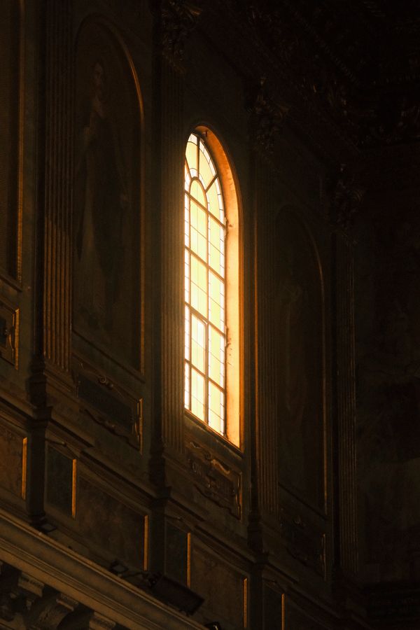 Golden light streaming through a church window
