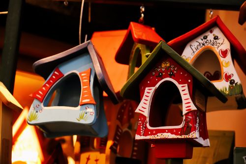 Free Vibrant handcrafted birdhouses in various colors, ideal for artful home decor and gift ideas. Stock Photo