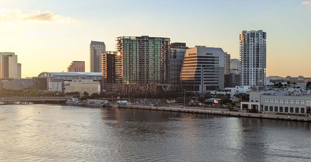 A stunning view of Tampa's skyline reflecting on the water at sunset.