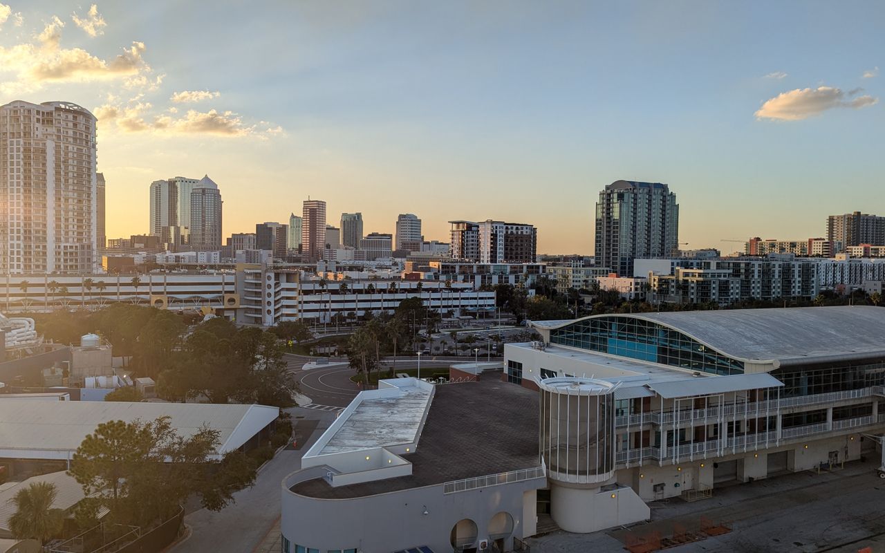 A stunning view of Tampa skyline at sunset, highlighting modern architecture and urban landscape.