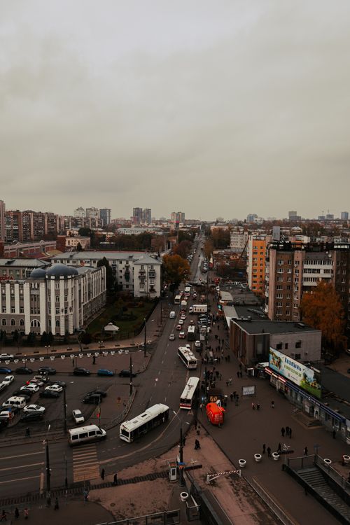 Free Aerial view of a busy city street with vehicles and pedestrians in autumn. Stock Photo