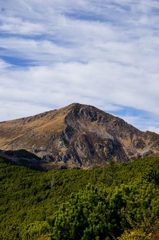 Majestic mountain view with clear blue sky and lush greenery in the foreground, inspiring natural scenery.