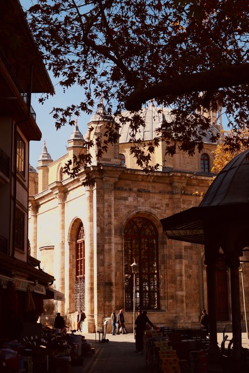 Free A historic mosque in Konya, Türkiye, viewed through autumnal trees, showcasing classic architecture. Stock Photo