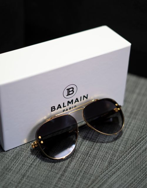 Free Elegant Balmain sunglasses alongside branded box on a stylish surface. Stock Photo
