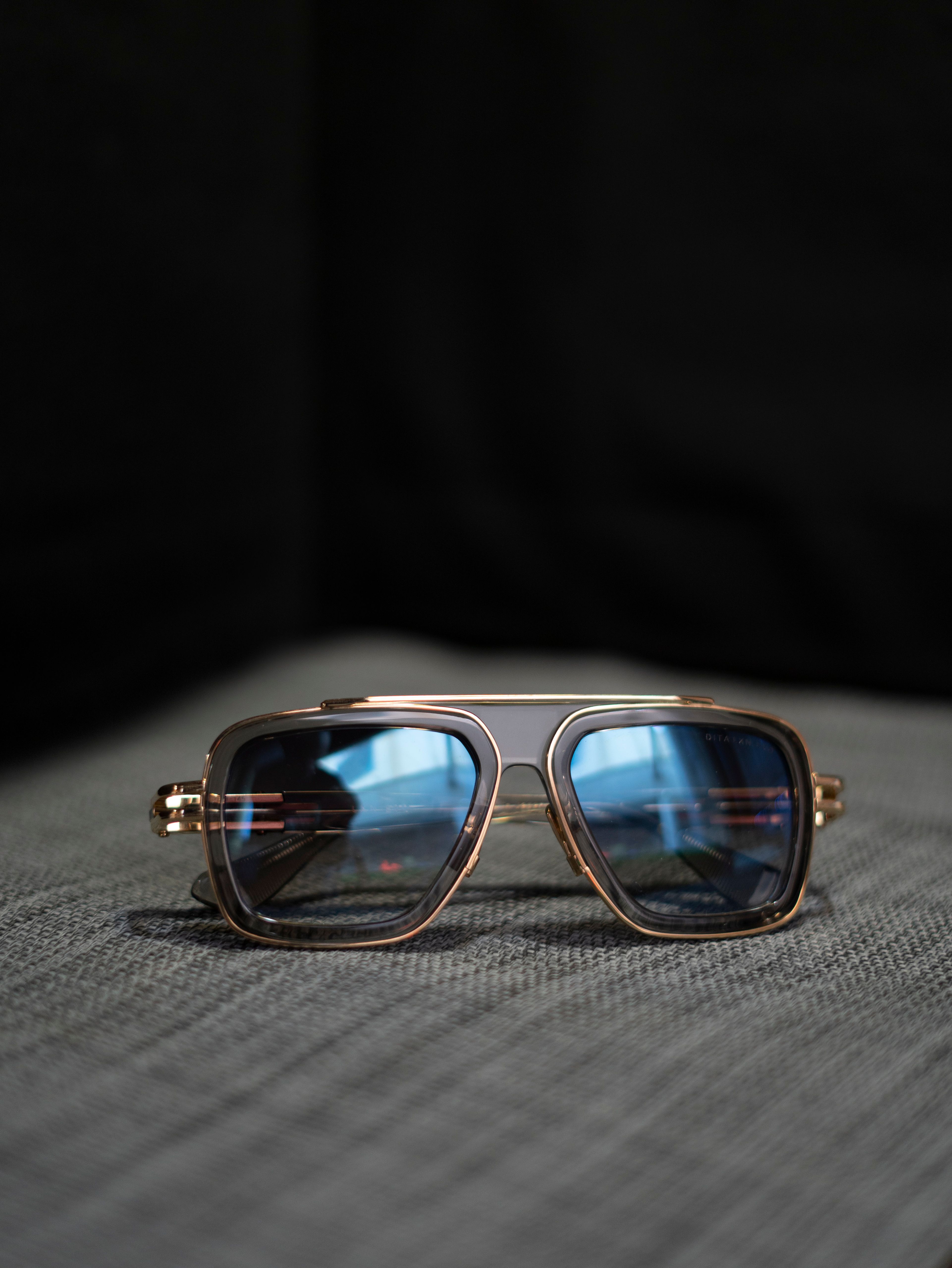 Aviator sunglasses with blue lenses and gold frame