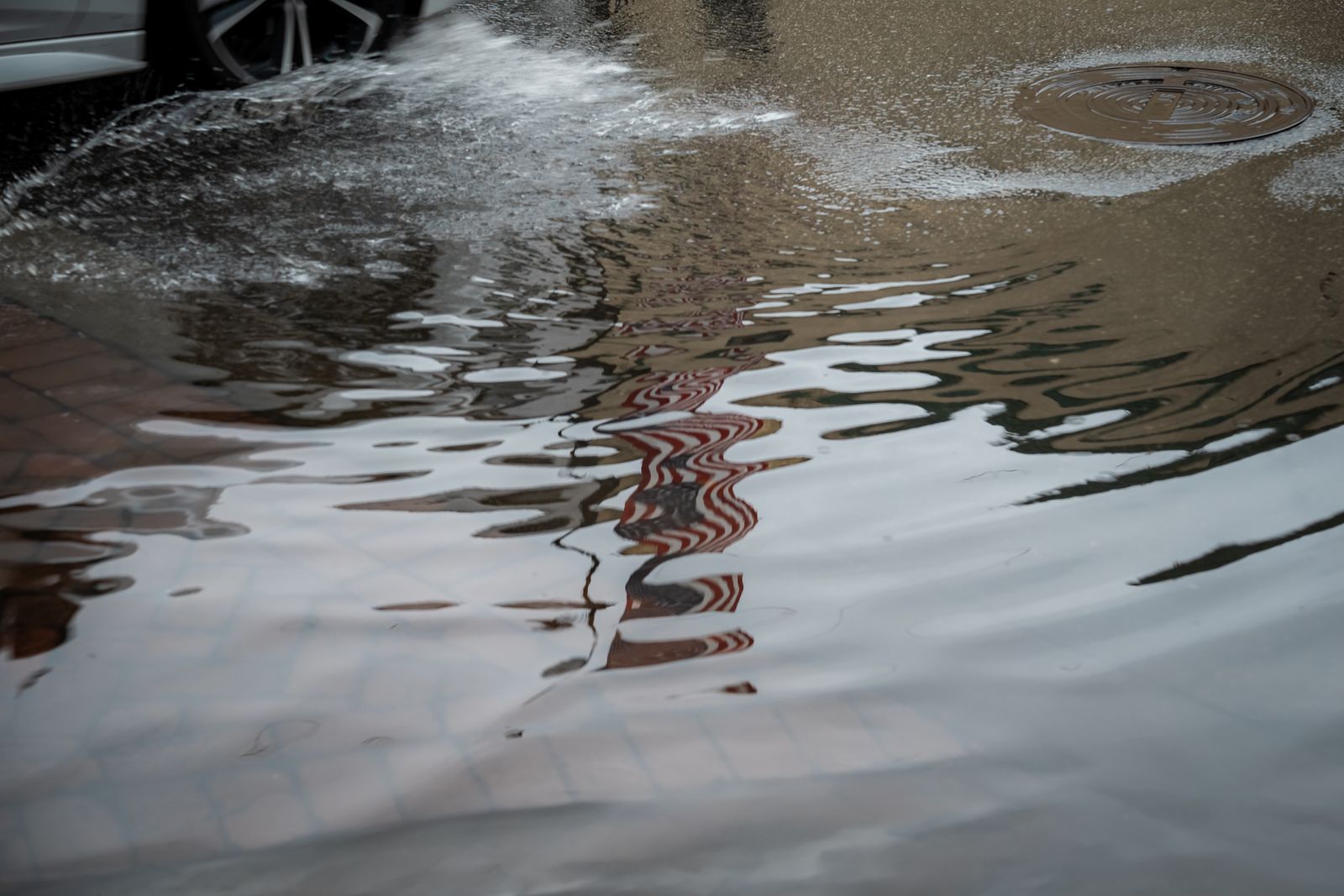 Standing water covering a city street after heavy rainfall