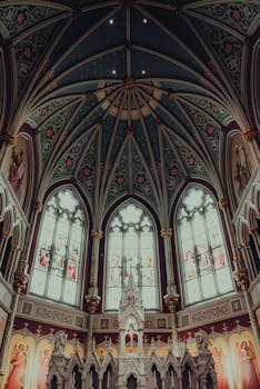 Ornate interior of a gothic cathedral in Savannah, showcasing intricate stained glass and architecture.