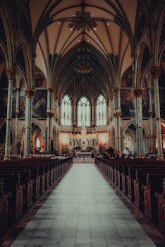 Stunning interior of a Gothic-style cathedral in Savannah, Georgia featuring intricate architecture and stained glass.