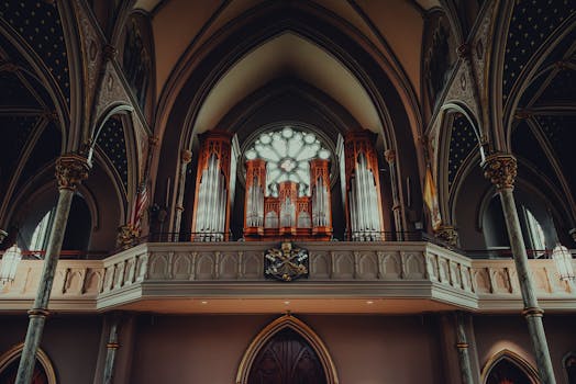 Detailed view of a gothic-style church interior featuring a grand pipe organ in Savannah, GA.