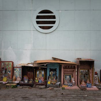 Colorful Buddhist shrines along a wall in Ho Chi Minh City, Vietnam's vibrant urban setting.
