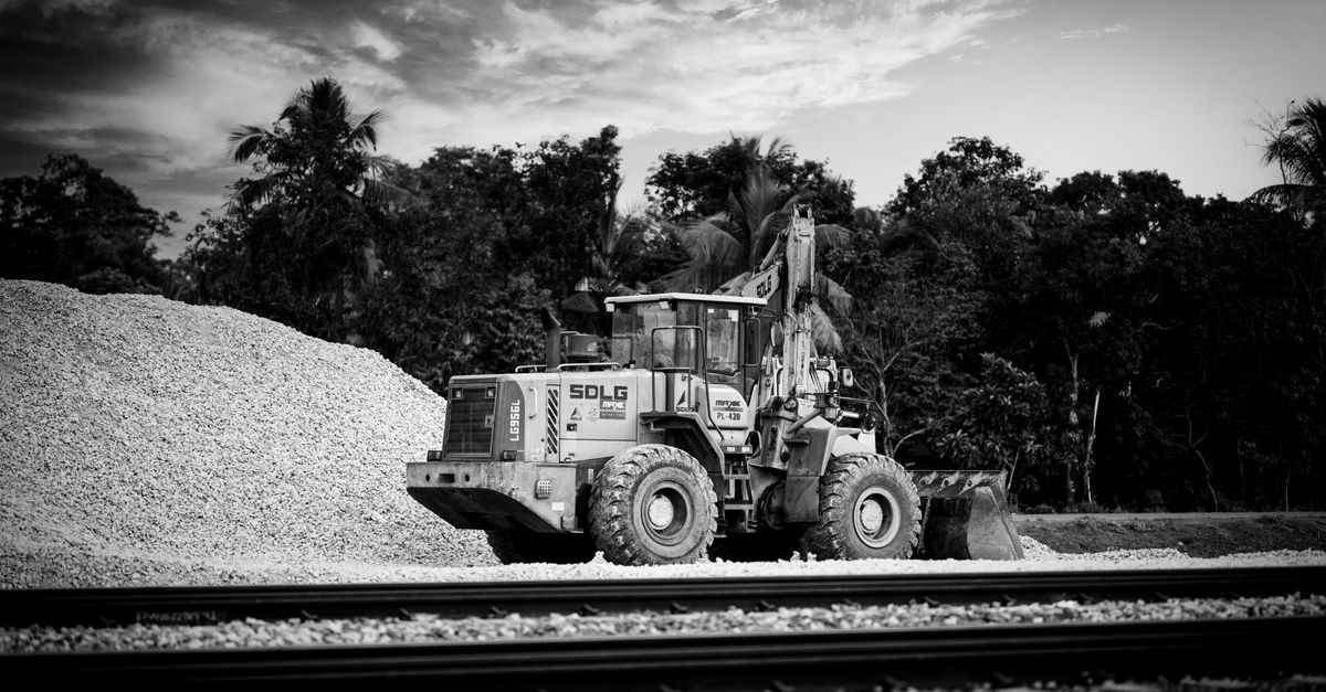 Monochrome photograph of an industrial loader at a construction site.