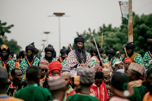 A vibrant cultural festival procession with people in traditional attire. Captures the essence of community and tradition.