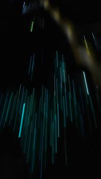 Dynamic abstract image of blue light streaks in motion over a dark background.