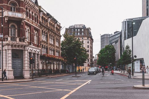 A bustling London street showcasing a blend of historic and modern architecture.