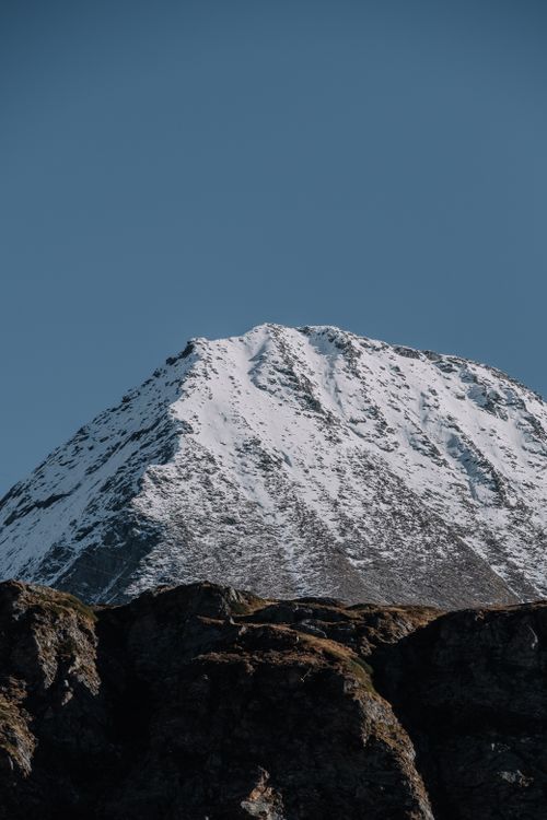 Free Stunning view of a snow-covered mountain under a bright blue sky, showcasing nature's beauty. Stock Photo